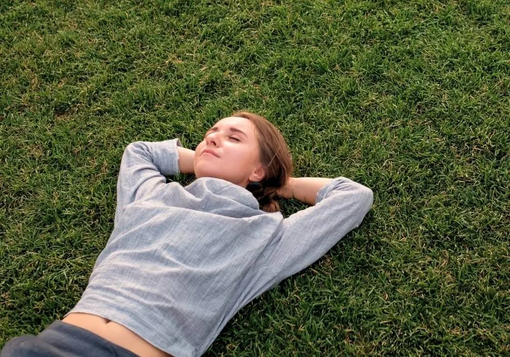 A person resting on grass, representing self-esteem therapy and a more secure sense of self
